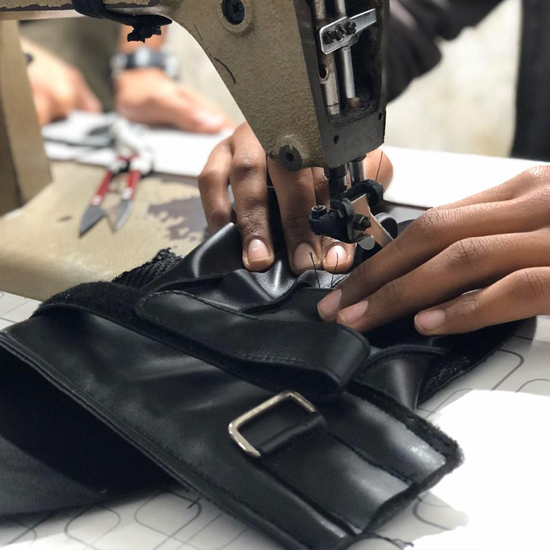 Industrial stitching on leather combat sports equipment at Deer Fight Gear manufacturing